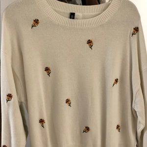 White sweater with embroidered flowers
